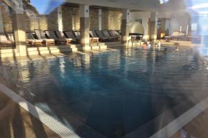 a swimming pool in a hotel with people in it at Apartments Milmari M 6.7.8 in Kopaonik