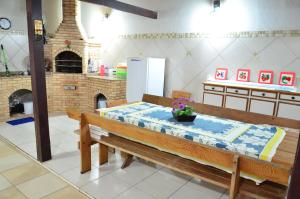 a kitchen with a table and a kitchen with a refrigerator at Cantinho do Canaã in Arraial do Cabo