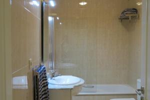 a bathroom with a sink and a toilet and a shower at Lenda do Mar in Vila Chã
