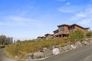 a house on the side of a hill with a road at Black Rock Ridge in Ucluelet