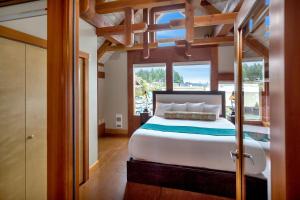 a bedroom with a bed and a large window at Black Rock Landing in Ucluelet