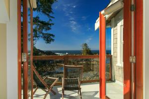 a balcony with chairs and a view of the ocean at Black Rock Beach House in Ucluelet