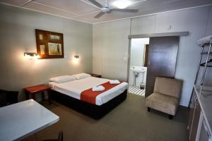 a hotel room with two beds and a television at Anchorage Motor Inn in Caloundra
