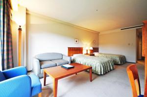 Кровать или кровати в номере Chokai Sarukuraonsen Hotel Foresta Chokai
