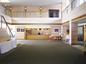 an empty lobby of a building with a desk at Chokai Sarukuraonsen Hotel Foresta Chokai in Yurihonjo