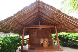 a small hut with two chairs and a roof at Mangrove Beach Cabana in Tangalle