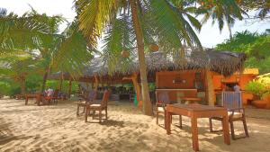 a group of tables and chairs on the beach at Mangrove Beach Cabana in Tangalle