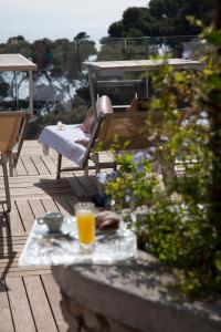 a glass of orange juice sitting on a patio at Hotel La Floridiana in Capri