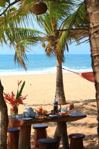 a table on the beach with a meal on it at Mangrove Beach Cabana in Tangalle