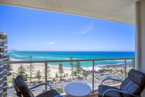 a room with a view of the beach and the ocean at Burleigh Beach Tower in Gold Coast