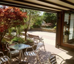 a patio with a table and chairs on a patio at Mercure Bergamo Aeroporto in Stezzano