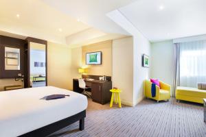 A bed or beds in a room at ibis Styles Sharjah