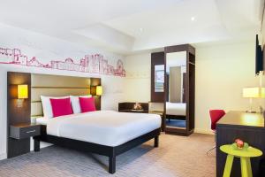 A bed or beds in a room at ibis Styles Sharjah