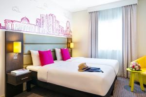 A bed or beds in a room at ibis Styles Sharjah