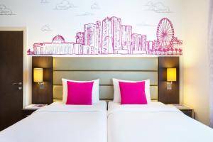 A bed or beds in a room at ibis Styles Sharjah