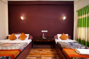 a room with two beds in a room at Sauraha Resort in Sauraha +37 photos