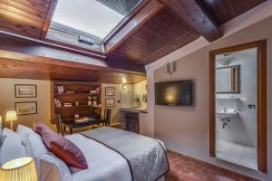 a bedroom with a bed and a bathroom with a sink at Locanda Dei Guelfi in Florence