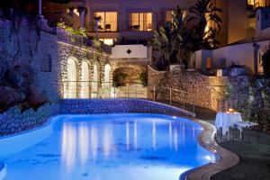 a swimming pool in a hotel at night at Hotel La Floridiana in Capri