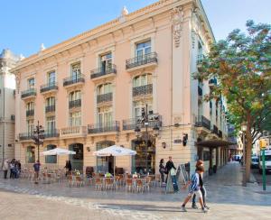 a large building with people walking in front of it at SH Ingles Boutique Hotel in Valencia