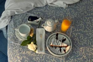 a table with a plate of food and a glass of orange juice at Hotel La Floridiana in Capri