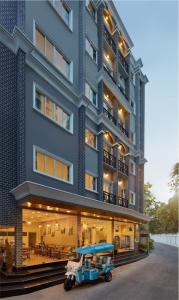 a blue building with a blue vehicle parked in front of it at Bangkok River Loka Hotel in Bangkok
