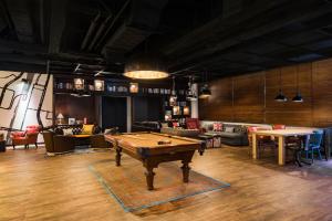 a room with a pool table in the middle of it at Pentahotel Hong Kong, Tuen Mun in Hong Kong