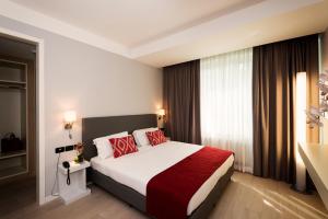 Postel nebo postele na pokoji v ubytování JR Hotels Gigli Firenze + 33 fotografií