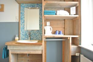 a bathroom with a sink and a mirror at Bed&Breakfast aan Strand in Katwijk aan Zee +67 photos