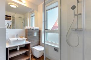 a bathroom with a toilet and a sink and a shower at Chrobry Apartamenty Gdańsk Grodzka 10 in Gdańsk +164 photos