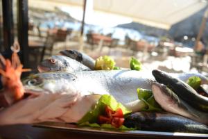 a plate of food with fish on a table at St. Patrick's Hotel in Xlendi