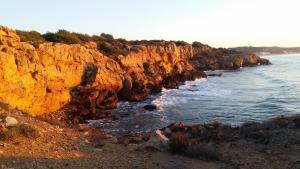 a view of a rocky shore with the ocean at Hotel Sant Jordi in Tarragona