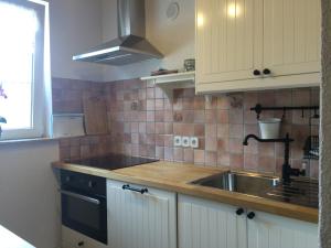 a kitchen with a sink and a stove at Alpenperle in Bichlbach