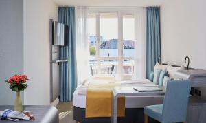 ein Hotelzimmer mit einem Bett, einem Schreibtisch und einem Fenster in der Unterkunft Living Hotel Kaiser Franz Joseph in Wien