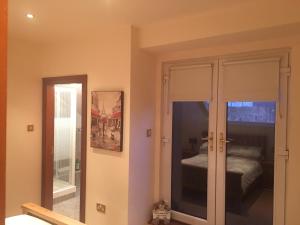 a room with a door leading to a bedroom at Riverside apartments Westport in Westport