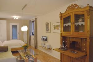 uma sala de estar com uma cama e um grande armário de madeira em Reisekultouren Apartments Detmold em Detmold