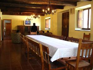 a dining room with a large white table and chairs at Brañuelas, Estacion 1 in Brañuelas