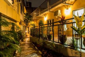 a courtyard of a building with a balcony with plants at Bricks Point - Boutique Apartments in Abuja