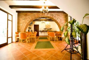 a kitchen and dining room with a brick archway at Curtea Brasoveana in Braşov