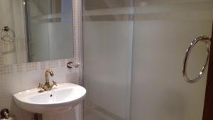 a bathroom with a sink and a shower at Casa Rural La Breña in Talaván