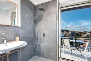 a bathroom with a shower and a sink and a balcony at Caruso 5 in Sorrento