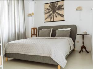 a bedroom with a large bed with a gray headboard at River View Studio in Bucharest