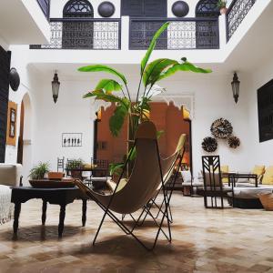 a living room with a chair and a piano at Riad Danka in Marrakesh