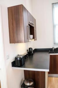 a kitchen with a counter top with a toaster and appliances at Four Princes Dock in Hull