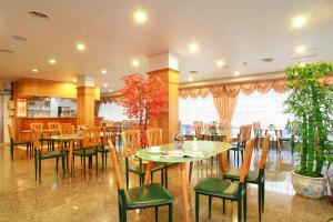 a restaurant with wooden tables and chairs and plants at Lidu Hotel in Suao