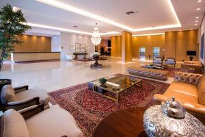 a large living room with couches and a table at Hotel Araucaria Flat in Araraquara