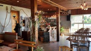 a restaurant with tables and chairs in a room at Viešbutis Ventainė in Ventė