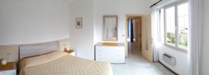 リモーネ・スル・ガルダにあるAppartamenti Villa Cliviaのベッドルーム1室(ベッド1台、ドレッサー、窓付)