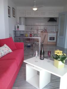 a living room with a red couch and a white table at Appartment Beach Golf in Benalmádena