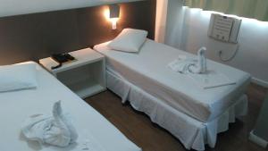 Cama ou camas em um quarto em Excellence Comfort Hotel