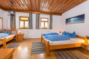 a bedroom with two beds and a wooden ceiling at Mirtl-Hoarl-Hof in Eschlkam